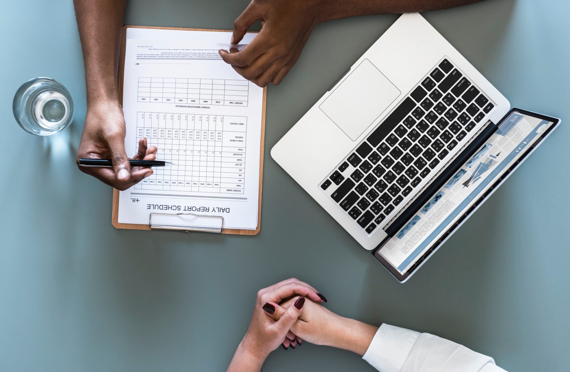 two people going over a daily report schedule