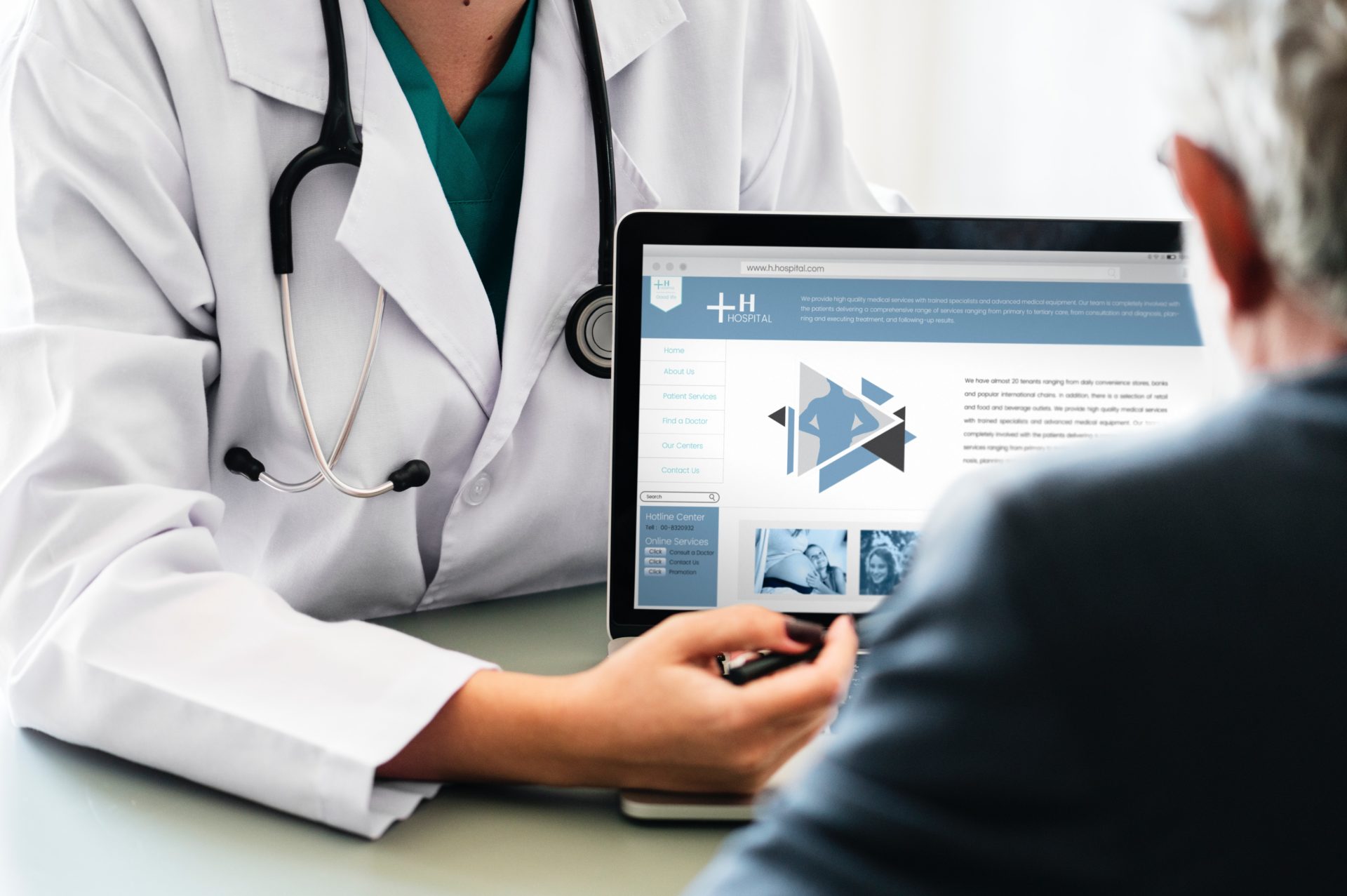 doctor explaining something to a patient on a laptop computer