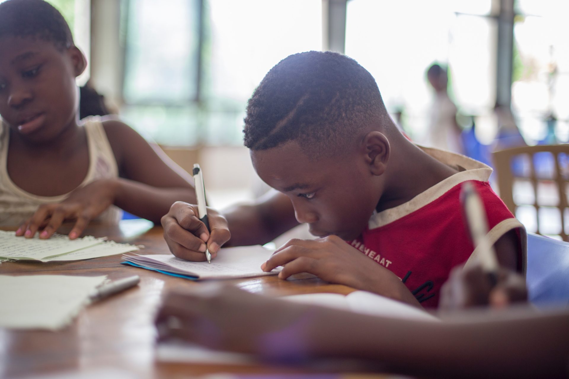 kids working on assignments at a table